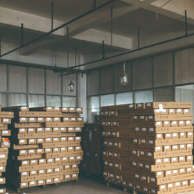 Stacks of cardboard boxes organized on pallets in a warehouse.