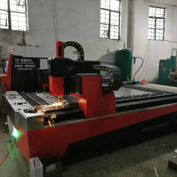 Industrial laser cutting machine in a factory producing AV mounting solutions.