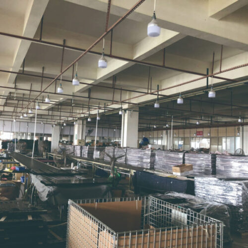 Spacious manufacturing facility for projector lifts with assembly stations and storage.