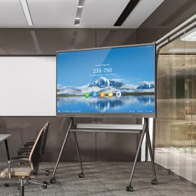 A large interactive smart display on a mobile stand in a modern conference room.