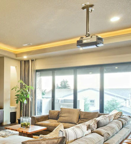 Spacious living room with a ceiling projector.