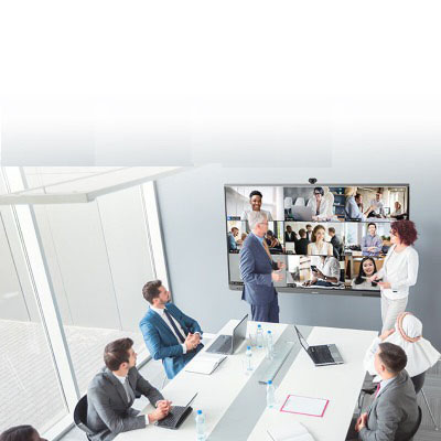 Business training session with a large screen for video conferencing in a modern room.