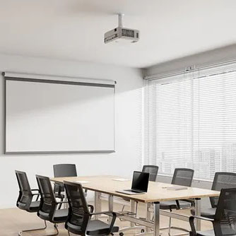 Conference room with a ceiling-mounted projector and whiteboard.