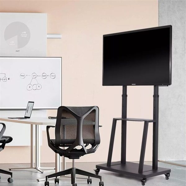 A mobile TV stand in a workspace with office chairs and a whiteboard.